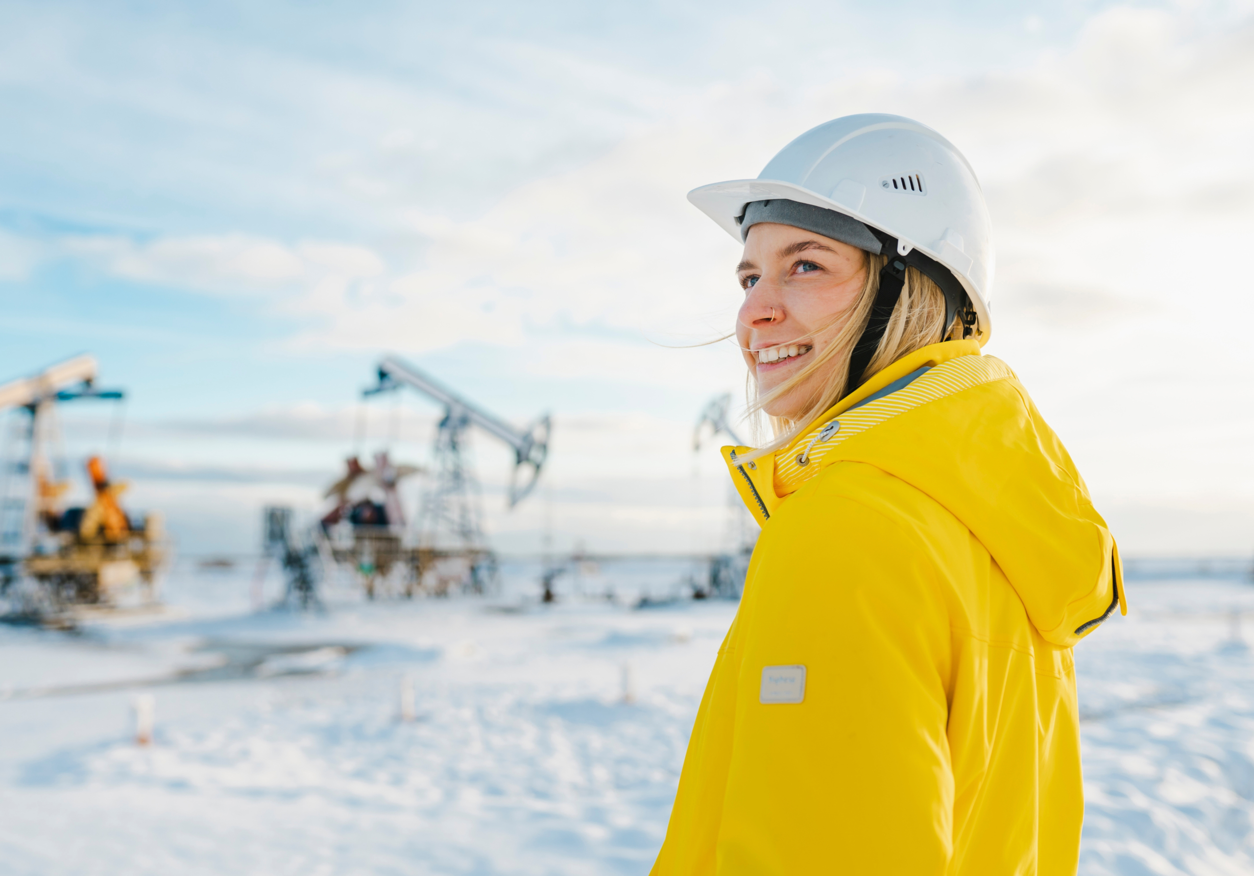 EHS Woman in yellow jacket at an oil rig